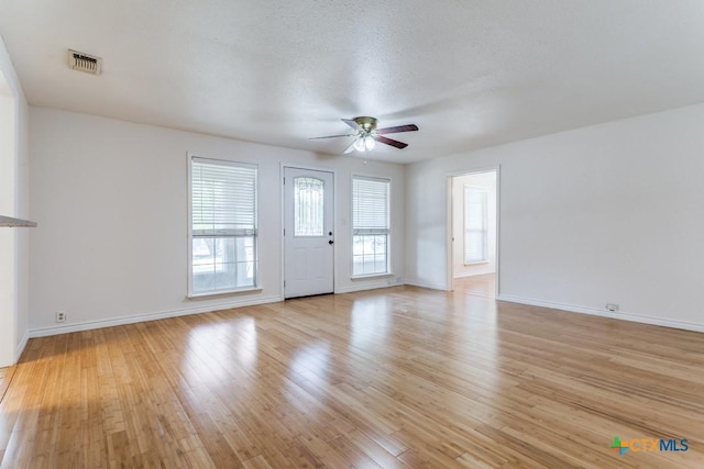 1488 Canyon Edge, Canyon Lake, TX 78133 - unfurnished living room featuring ceiling fan, light wood-style flooring, and baseboards