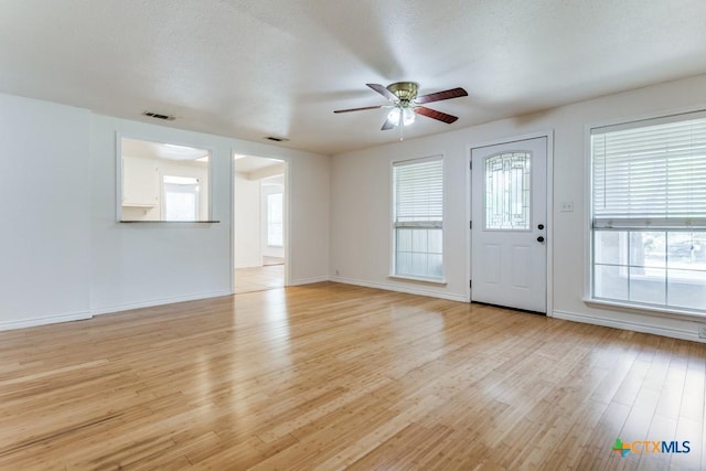 1488 Canyon Edge, Canyon Lake, TX 78133 - unfurnished living room with a ceiling fan, light wood-style flooring, and baseboards