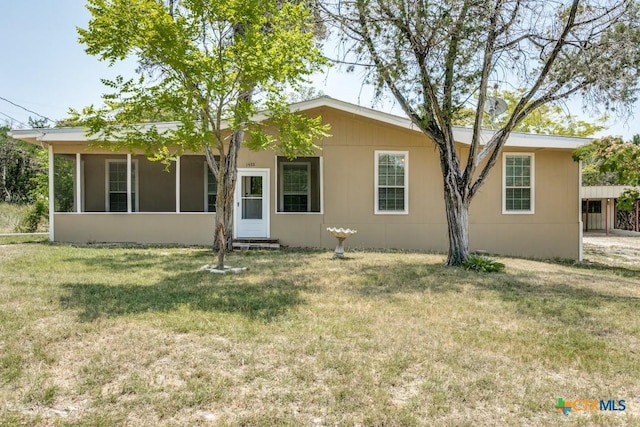 1488 Canyon Edge, Canyon Lake, TX 78133 - view of front of home featuring a front yard, entry steps, and a sunroom