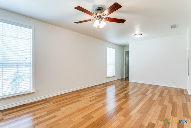 1488 Canyon Edge, Canyon Lake, TX 78133 - spare room featuring plenty of natural light, light wood-style flooring, a ceiling fan, and baseboards