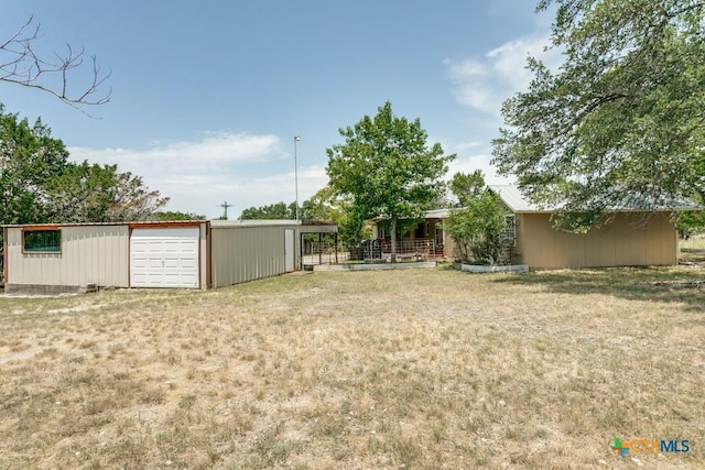 1488 Canyon Edge, Canyon Lake, TX 78133 - view of grassy yard with a detached garage and an outbuilding