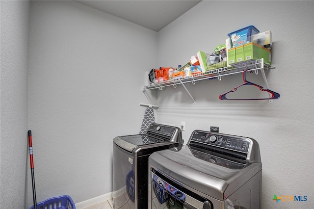 laundry area with tile patterned flooring and washing machine and dryer