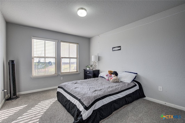 bedroom with a textured ceiling and carpet floors