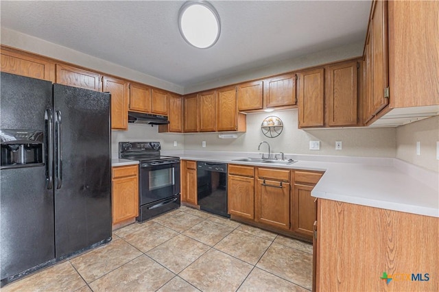 2405 Thoroughbred Dr, Killeen, TX 76549 - kitchen featuring brown cabinetry, black appliances, under cabinet range hood, and a sink