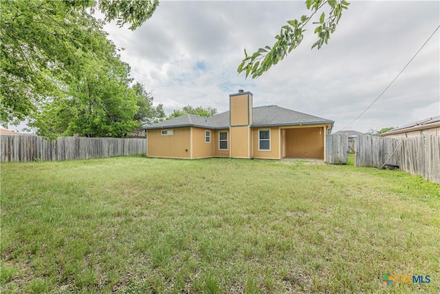 2405 Thoroughbred Dr, Killeen, TX 76549 - back of house featuring a fenced backyard, a chimney, and a yard