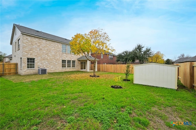 exterior space featuring a lawn, central AC, and a storage shed