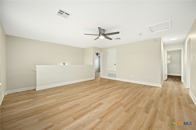 empty room with ceiling fan and light hardwood / wood-style floors