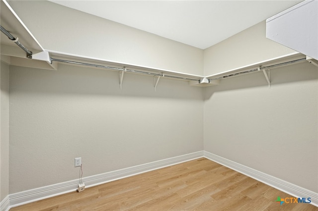 spacious closet featuring hardwood / wood-style floors