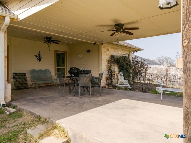 view of patio / terrace featuring ceiling fan, outdoor dining space, and fence