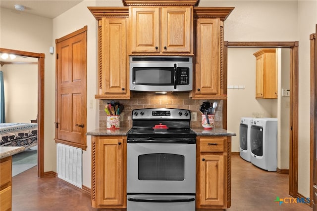 kitchen with visible vents, tasteful backsplash, appliances with stainless steel finishes, and washing machine and clothes dryer