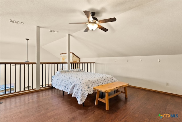 bedroom featuring vaulted ceiling, visible vents, and wood finished floors