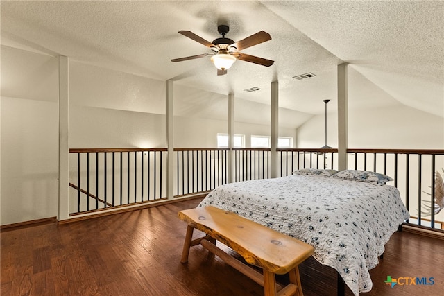 bedroom featuring visible vents, wood finished floors, and vaulted ceiling