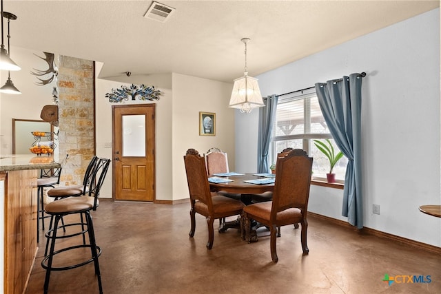 dining area featuring visible vents, baseboards, a textured ceiling, and finished concrete flooring