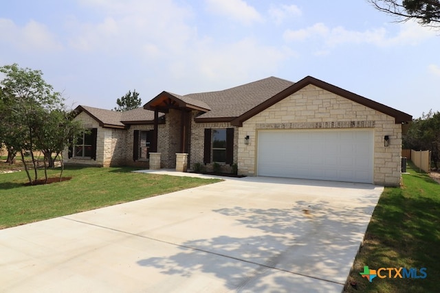 view of front of home featuring a front yard and a garage