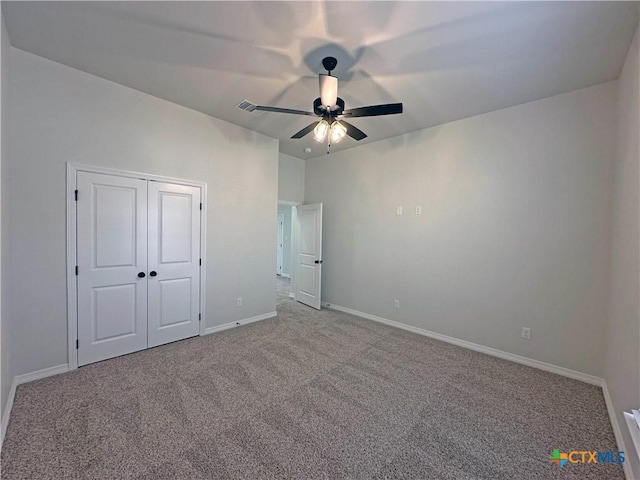 unfurnished bedroom featuring a closet, visible vents, carpet flooring, ceiling fan, and baseboards