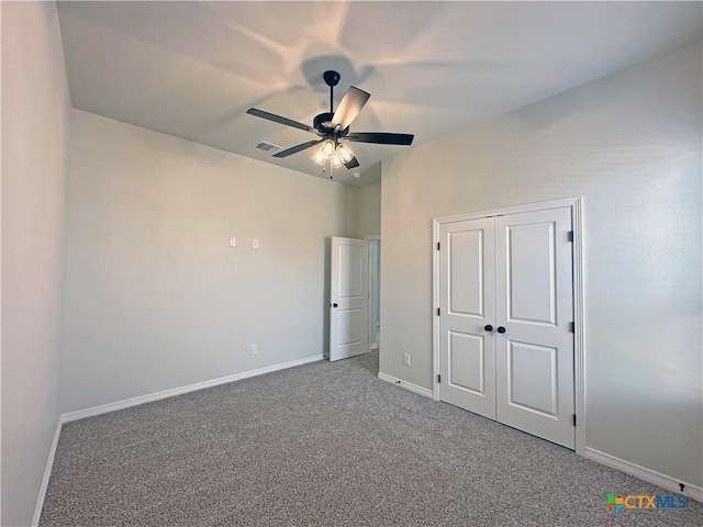 unfurnished bedroom with carpet floors, a ceiling fan, visible vents, baseboards, and a closet