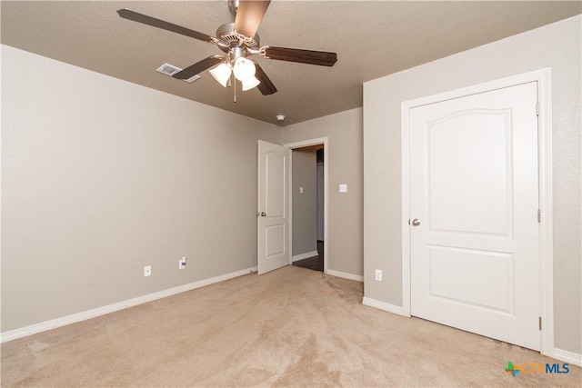 605 Draper Dr, Temple, TX 76504 - unfurnished bedroom with light colored carpet, baseboards, and a ceiling fan