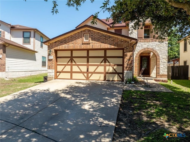 9108 Sage Loop Ct, Temple, TX 76502 - view of front of home with stone siding, an attached garage, concrete driveway, and brick siding
