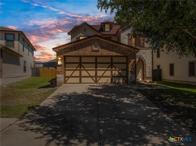9108 Sage Loop Ct, Temple, TX 76502 - view of front of home featuring stone siding, concrete driveway, an attached garage, and brick siding