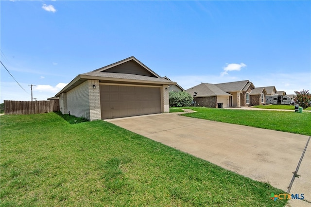 ranch-style home with a garage and a front lawn