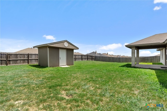 view of yard featuring a shed and a patio area