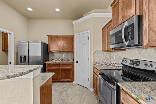 kitchen featuring decorative backsplash, light stone counters, and stainless steel appliances