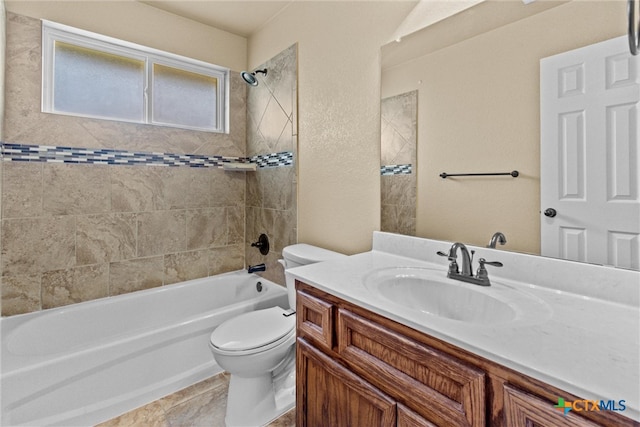 full bathroom with tile patterned flooring, tiled shower / bath, toilet, and vanity