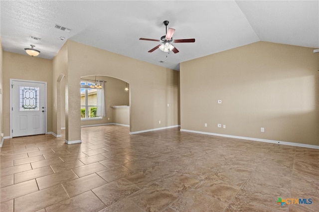 interior space featuring ceiling fan with notable chandelier and lofted ceiling