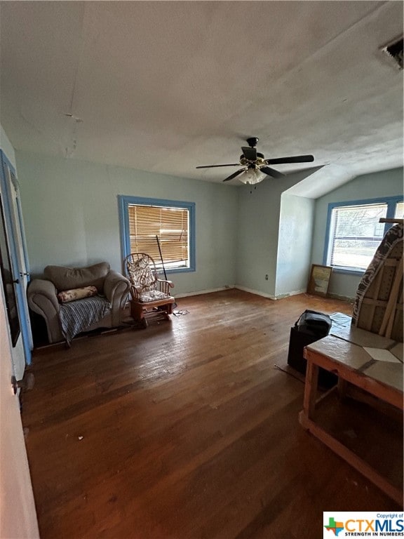 living room featuring hardwood / wood-style flooring, ceiling fan, and vaulted ceiling