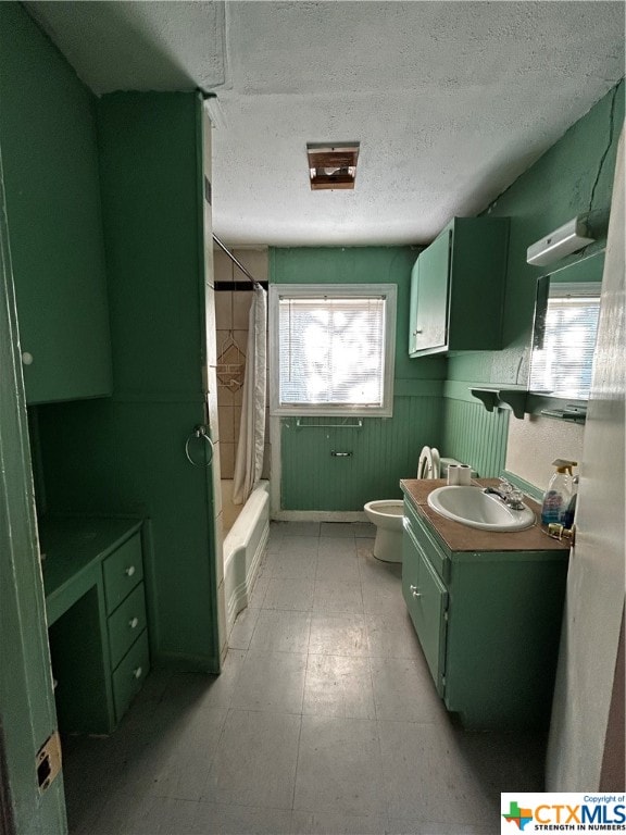 full bathroom with toilet, vanity, shower / bath combination with curtain, and a textured ceiling