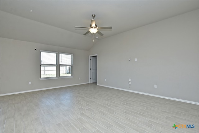132 Periwinkle Ln, Bastrop, TX 78602 - spare room with vaulted ceiling, a ceiling fan, light wood-style floors, and baseboards