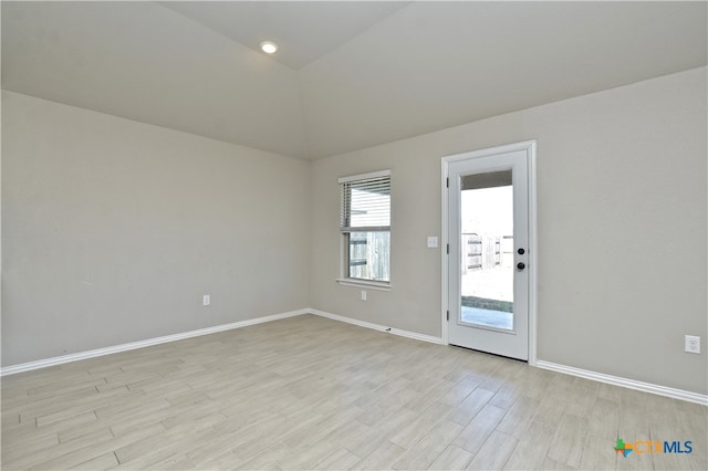 132 Periwinkle Ln, Bastrop, TX 78602 - empty room featuring baseboards, light wood-type flooring, and lofted ceiling