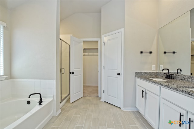 132 Periwinkle Ln, Bastrop, TX 78602 - bathroom featuring a spacious closet, a stall shower, a garden tub, and a sink