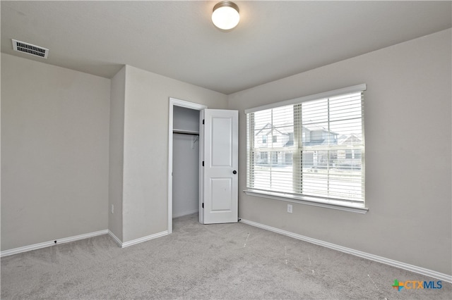 132 Periwinkle Ln, Bastrop, TX 78602 - unfurnished bedroom with a closet, visible vents, baseboards, and carpet