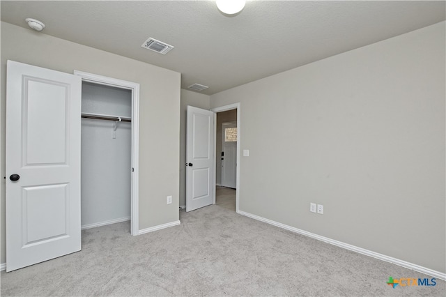 132 Periwinkle Ln, Bastrop, TX 78602 - unfurnished bedroom featuring visible vents, baseboards, a closet, and carpet flooring