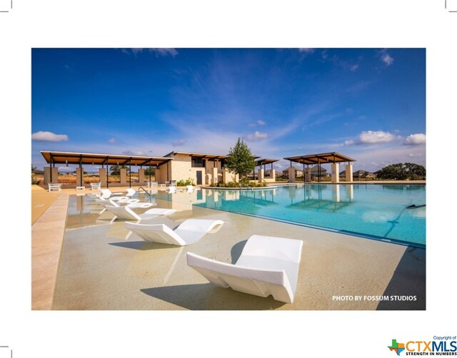 view of swimming pool with a gazebo and a patio area