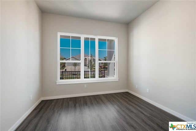 spare room featuring dark hardwood / wood-style flooring