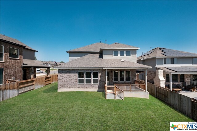 back of house with a patio and a yard