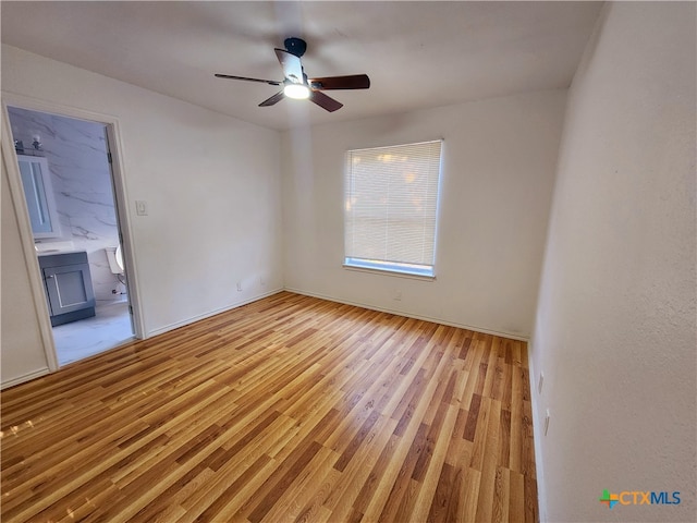 unfurnished room with light wood-type flooring and ceiling fan