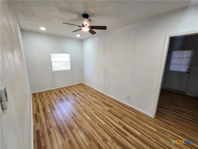 spare room featuring hardwood / wood-style floors and ceiling fan