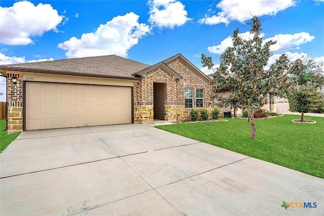 single story home featuring brick siding, concrete driveway, a front yard, a garage, and stone siding