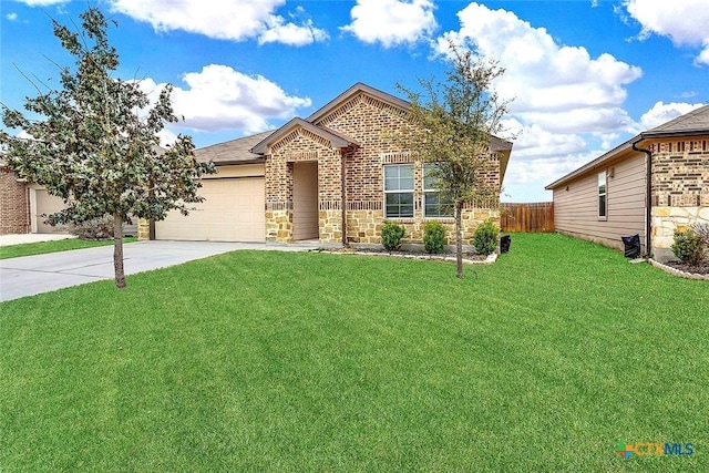 view of front of property with an attached garage, fence, driveway, stone siding, and a front yard