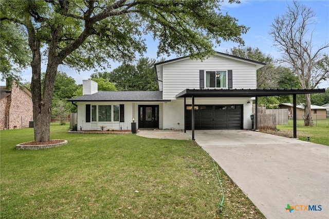 traditional-style home with concrete driveway, a chimney, an attached garage, fence, and a front lawn