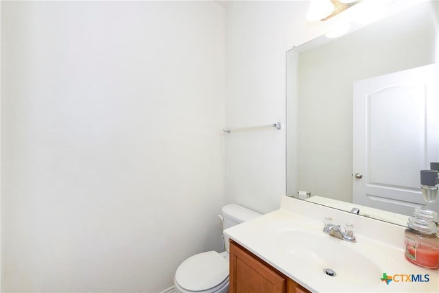 bathroom featuring toilet and vanity