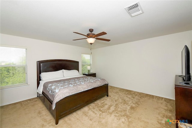 bedroom with ceiling fan and light carpet