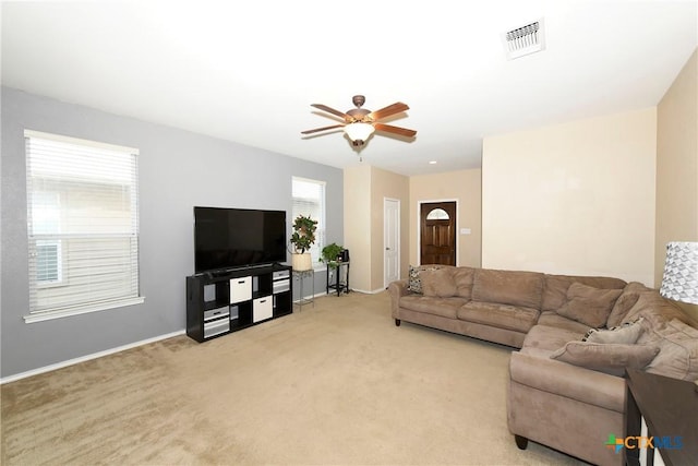 carpeted living room featuring ceiling fan