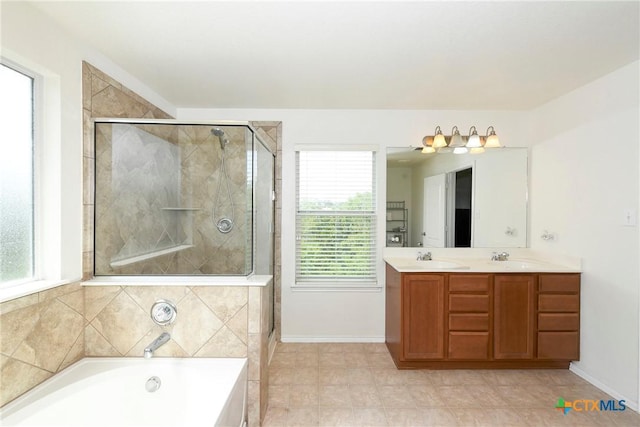 bathroom featuring plenty of natural light, vanity, and plus walk in shower