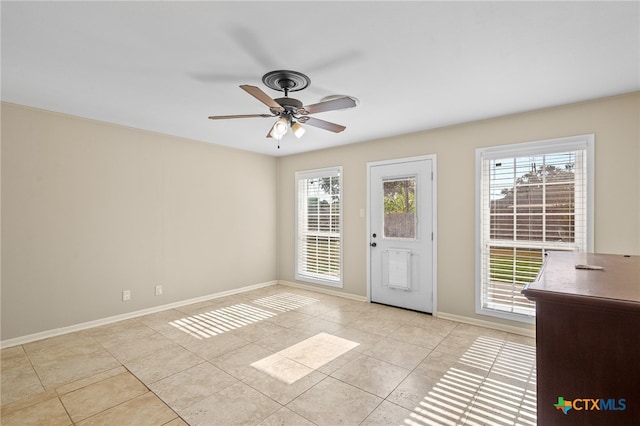 doorway with light tile patterned flooring and ceiling fan