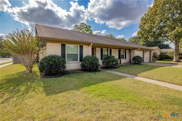 ranch-style house with a garage and a front lawn