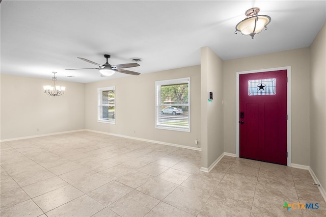 tiled entryway with ceiling fan with notable chandelier